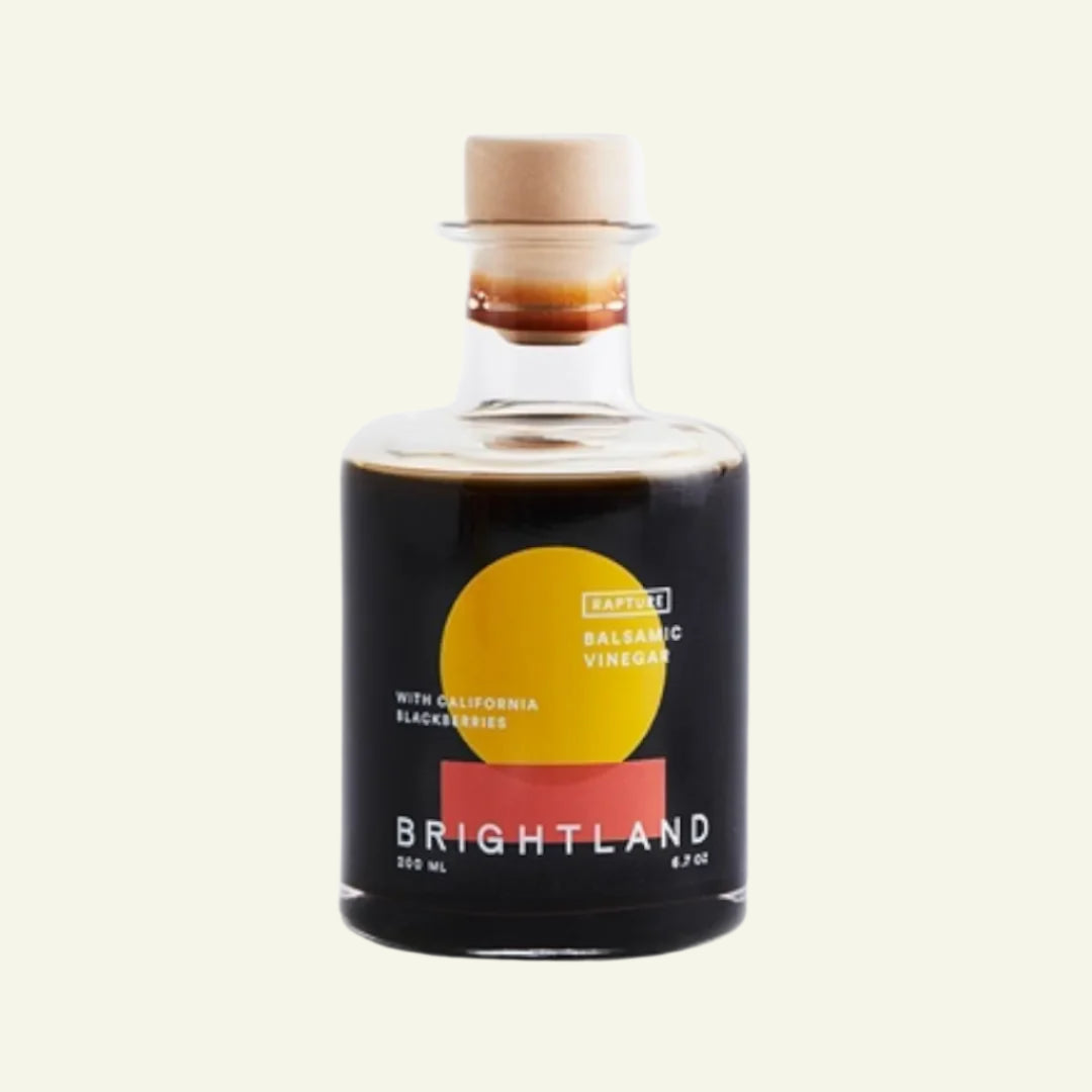 Bottle of Brightland balsamic vinegar on a white background