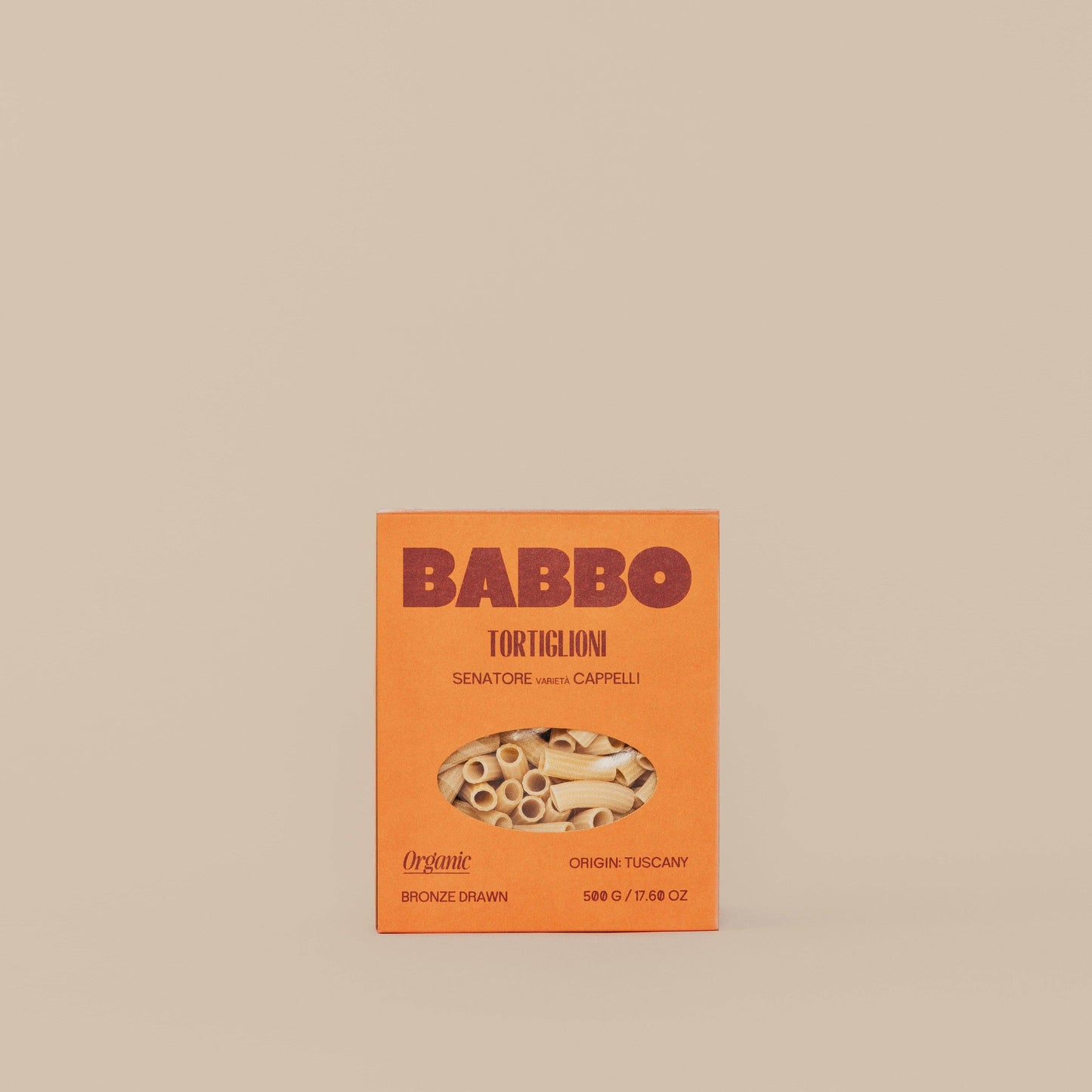 Package of Babbo Tortiglioni pasta with an orange and white design, featuring an image of the pasta and the brand name.