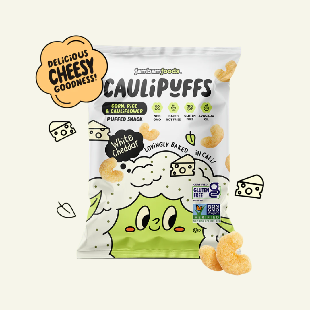A bag of CauliPuffs White Cheddar Puffs with the product visible in the foreground. The packaging is mainly white with green accents and illustrations of cauliflower and puffs.