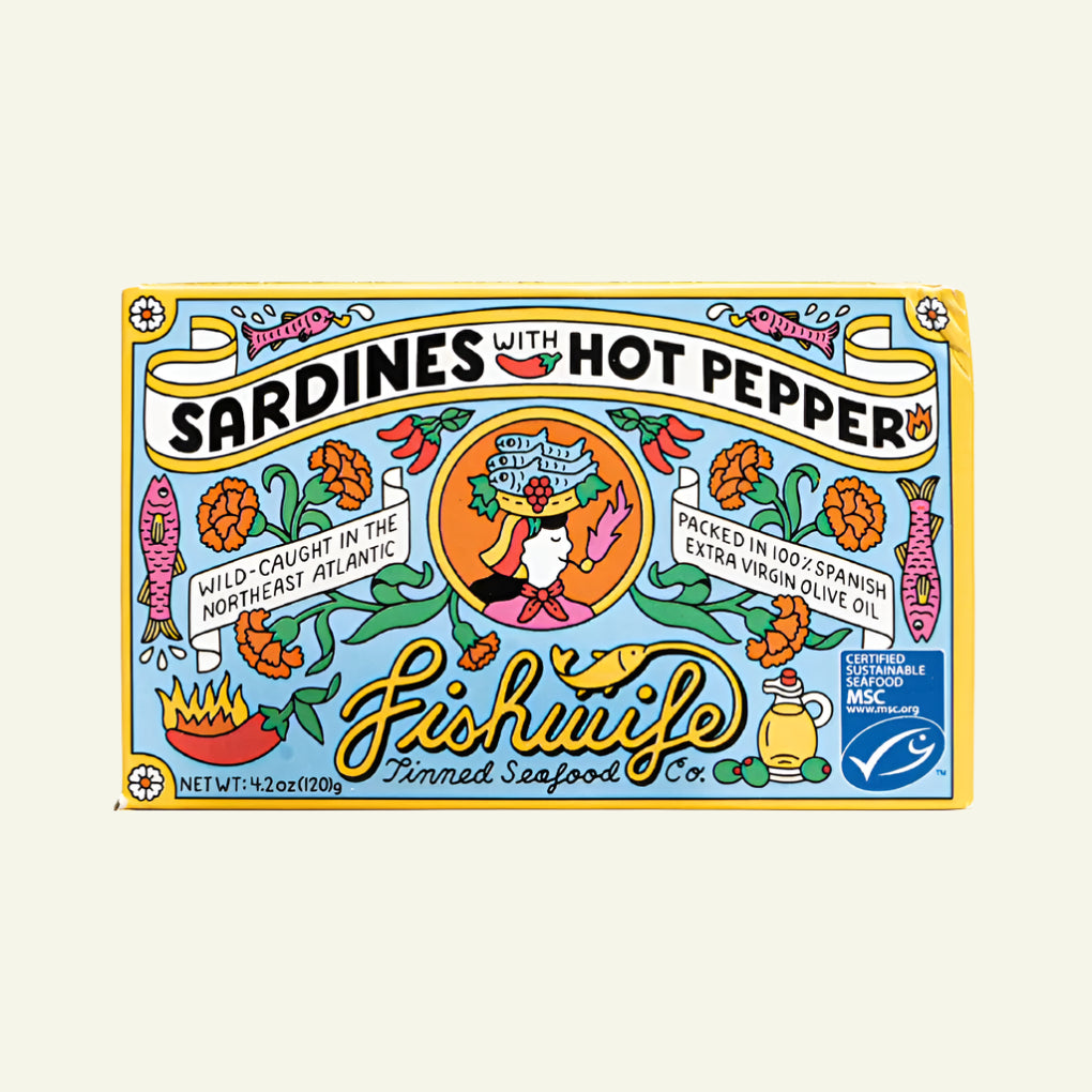 Packaging for Fishwife Sardines with Hot Pepper, displaying the product name and illustrations of sardines, a hot pepper, and related kitchen imagery.