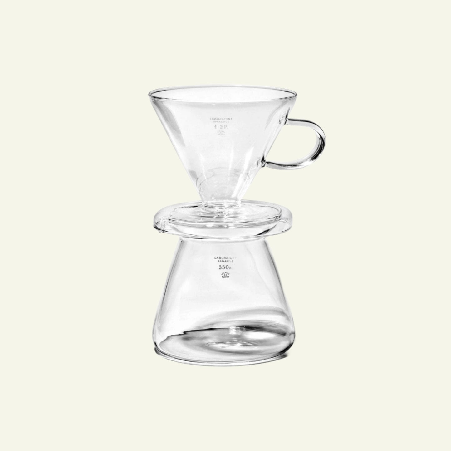 Clear glass coffee brewing device on a white background