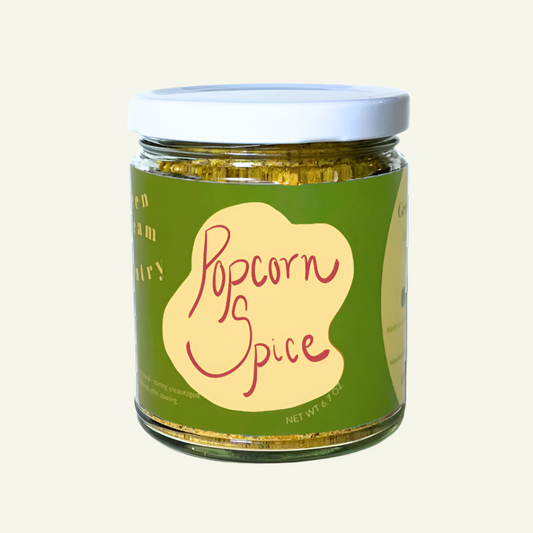 Jar of popcorn spice with a green label on a white background