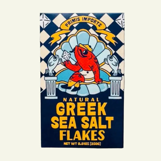 Box of Primis Imports Natural Greek Sea Salt Flakes on a marble background