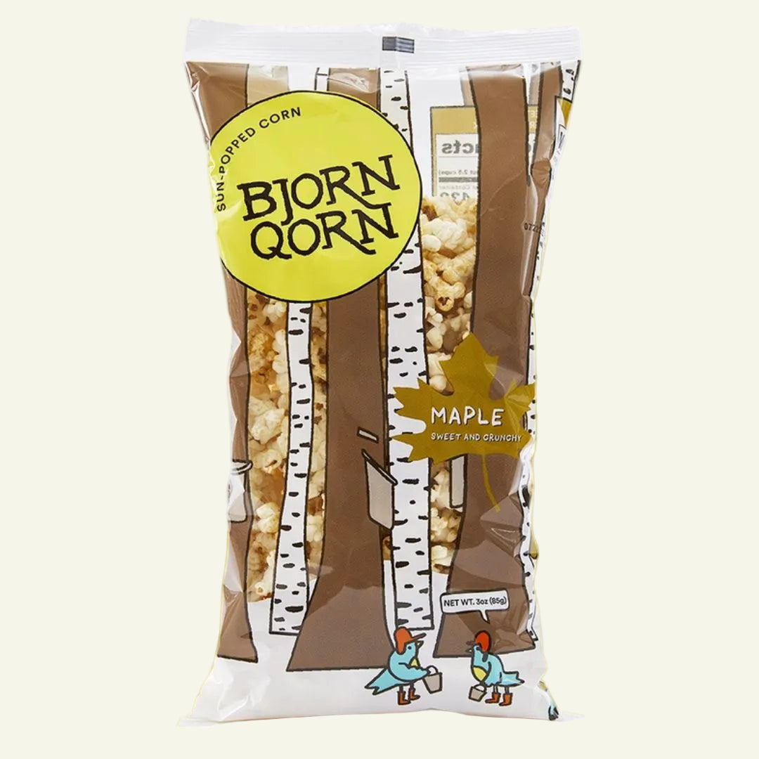 Bjorn Qorn maple flavored popcorn package on a white and yellow background
