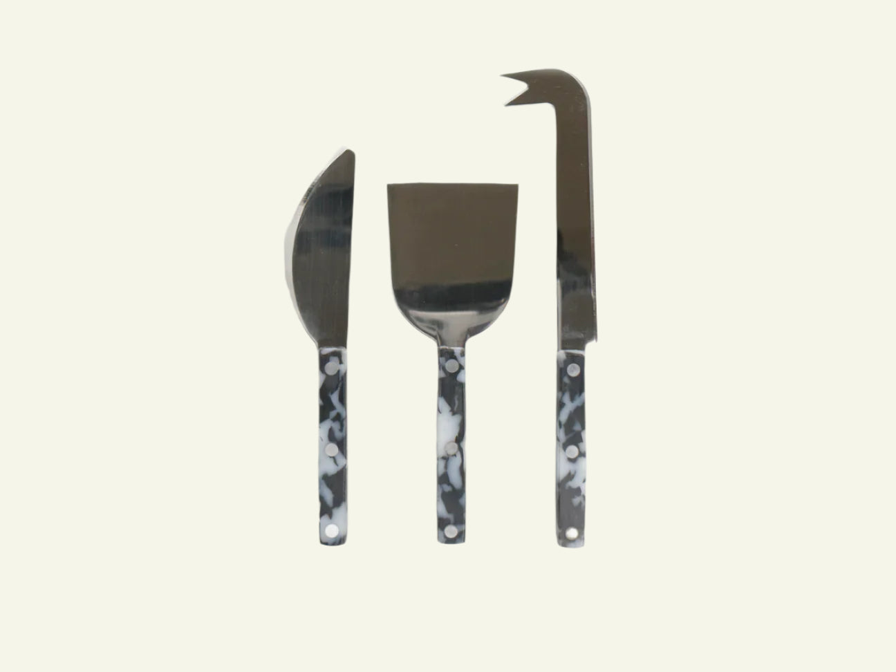 A set of three cheese knives with black and white handles, including a pointed knife, a curved knife, and a broad blade knife.