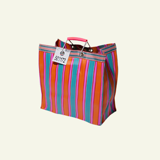 A hand-woven striped tote bag in orange and pink with strong aluminum handles, displayed against a white background with a shadow cast on the ground.